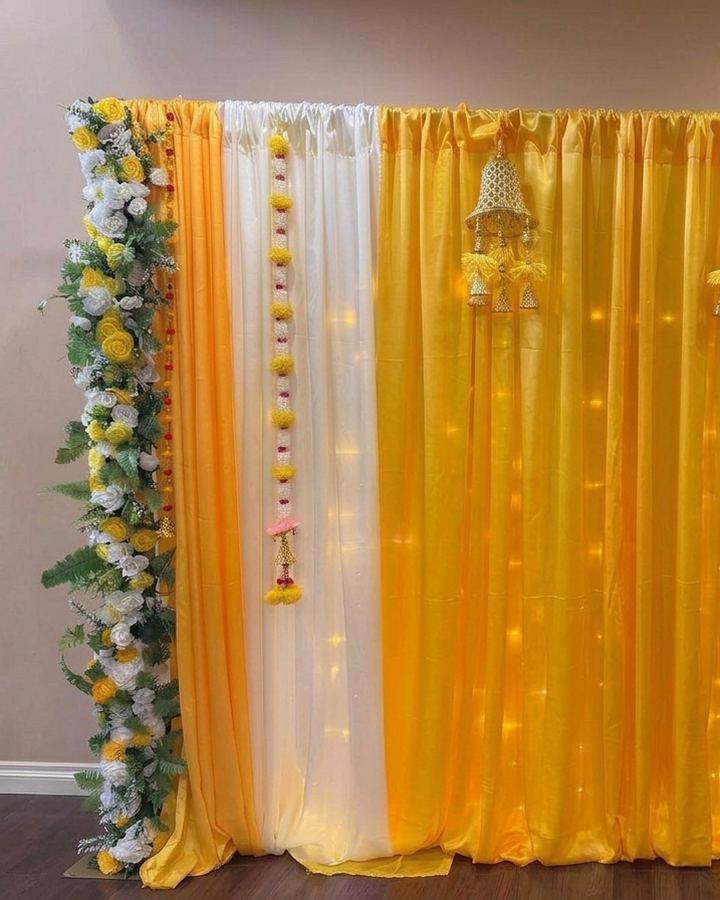 Haldi backdrop with marigold strings and floral pillars, Calgary